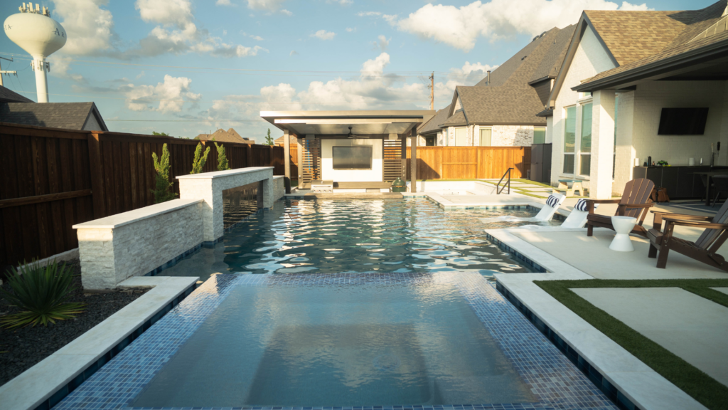 "Modern backyard pool with raised spa, covered pavilion, and outdoor lounge area."